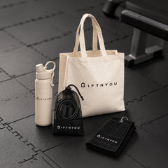 The Active Day Kit by GiftNYou with beige water bottle with carry loop, black skipping rope with mesh storage pouch, black sports towel with hanging loop in a fitness setting