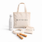 The Daily Movement Kit by GiftNYou with white water bottle, skipping rope with wooden handles, small natural-coloured drawstring pouch on a white background