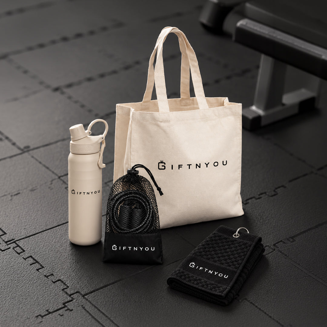 The Active Day Kit by GiftNYou with beige water bottle with carry loop, black skipping rope with mesh storage pouch, black sports towel with hanging loop in a fitness setting