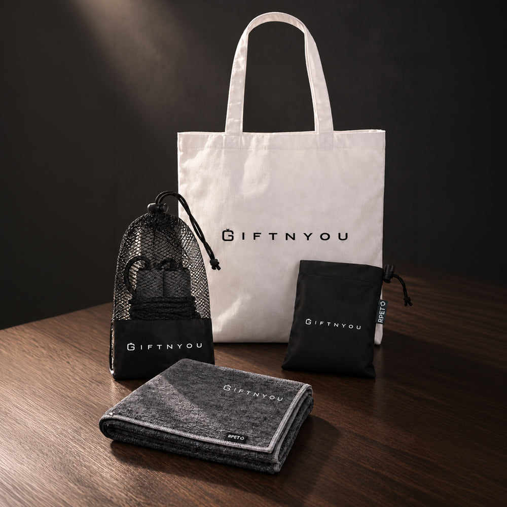 The Move Together Kit by GiftNYou with black skipping rope with mesh storage pouch, grey sports towel, black drawstring storage pouch in a fitness setting