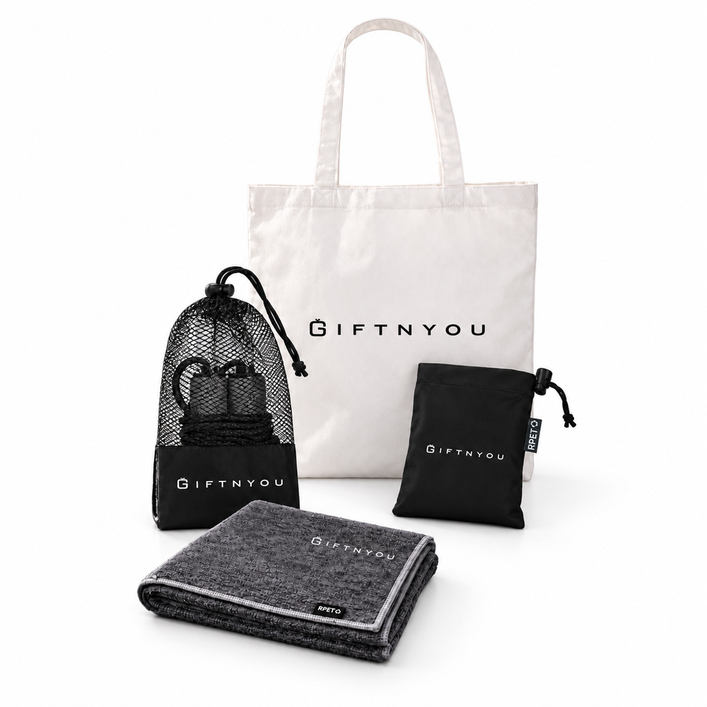 The Move Together Kit by GiftNYou with black skipping rope with mesh storage pouch, grey sports towel, black drawstring storage pouch on a white background
