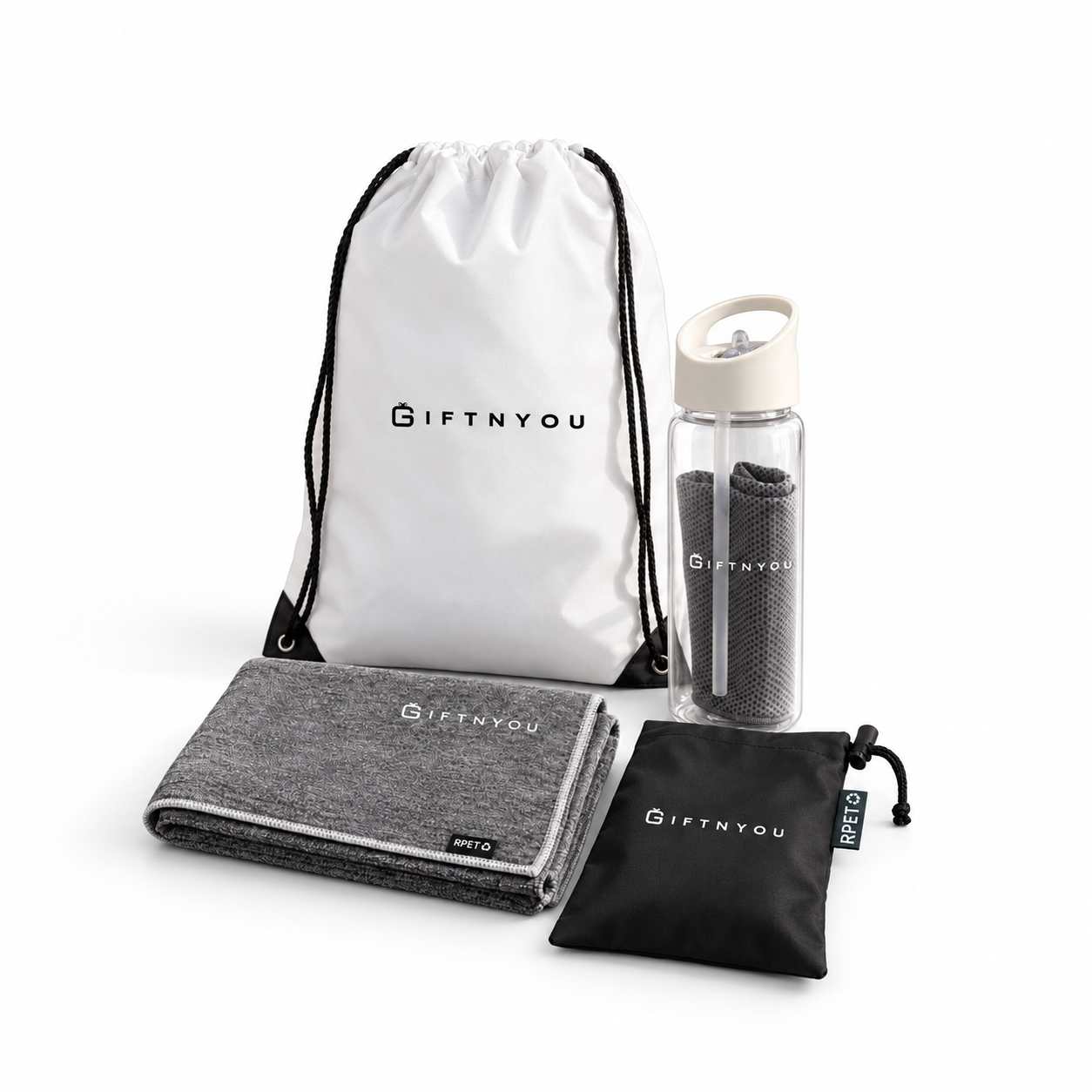 The Active Refresh Kit by GiftNYou with clear bottle with carry handle and grey towel inside, additional grey sports towel, black drawstring storage pouch on a white background
