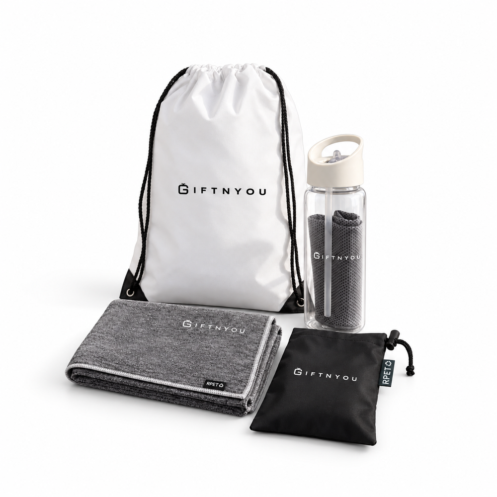 The Active Refresh Kit by GiftNYou with clear bottle with carry handle and grey towel inside, additional grey sports towel, black drawstring storage pouch on a white background